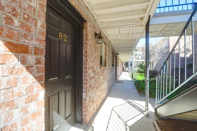 property entrance featuring brick siding