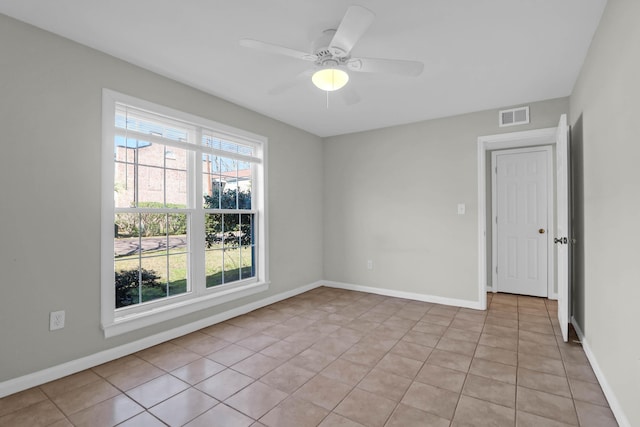 unfurnished room with visible vents, ceiling fan, baseboards, and light tile patterned flooring