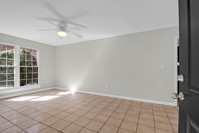 unfurnished room featuring ceiling fan and baseboards