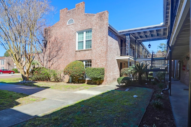 view of side of home with brick siding