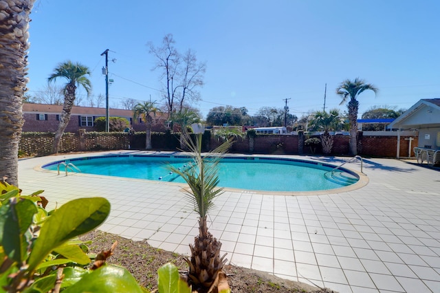 view of pool featuring a fenced in pool, a patio area, and fence