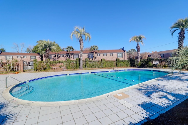 pool featuring fence and a residential view