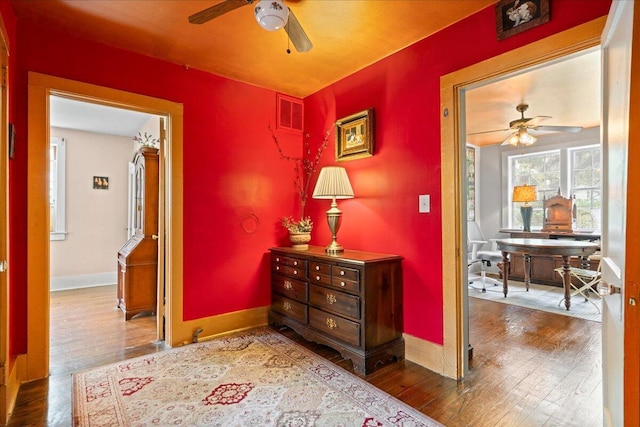 hall with wood-type flooring