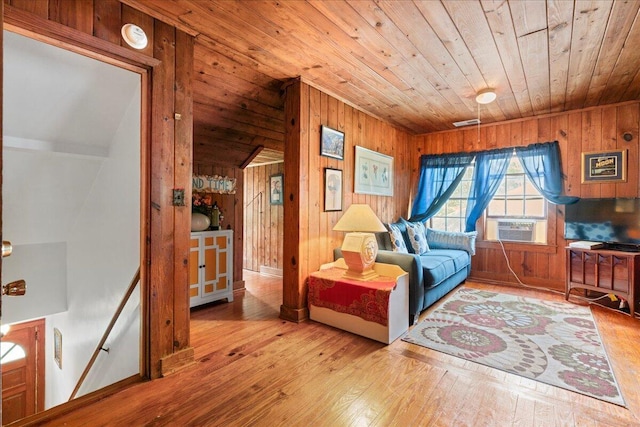 sitting room featuring wood walls, light wood-type flooring, and wooden ceiling