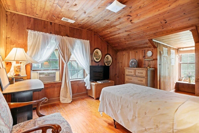 bedroom with wood ceiling, cooling unit, light hardwood / wood-style floors, lofted ceiling, and wood walls