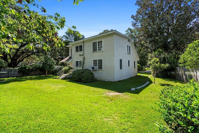 rear view of property featuring a yard