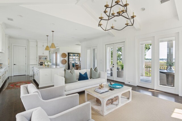 living room with an inviting chandelier, a healthy amount of sunlight, and wood-type flooring