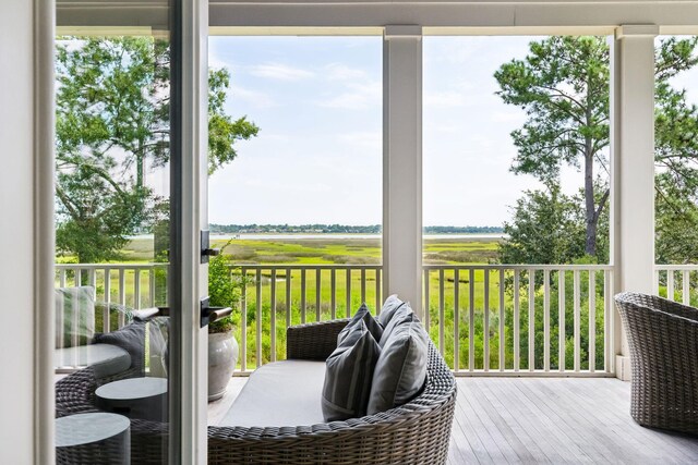 sunroom featuring a wealth of natural light and ceiling fan