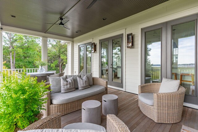 sunroom / solarium featuring ceiling fan