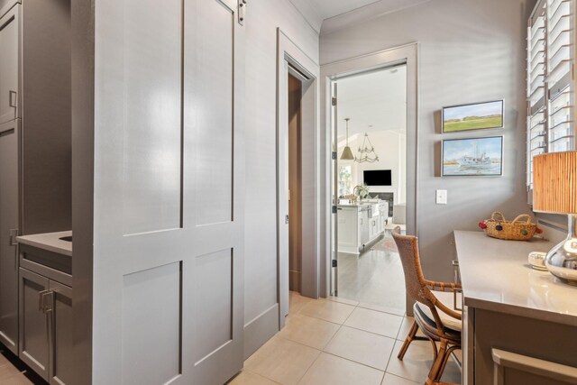 mudroom featuring light tile patterned flooring and ornamental molding