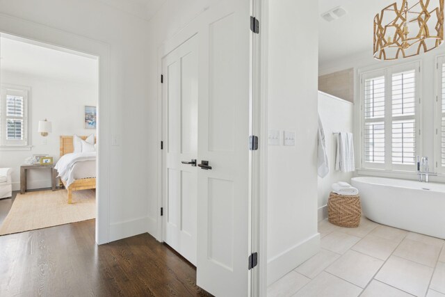 bathroom featuring tile patterned floors, ornamental molding, independent shower and bath, and vanity