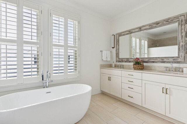 bathroom with a tile shower and vanity