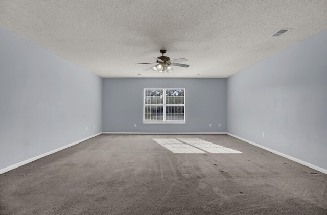 carpeted empty room featuring ceiling fan and a textured ceiling