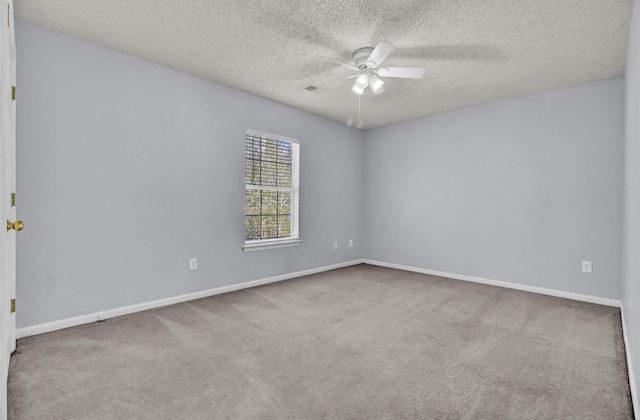 empty room featuring ceiling fan, a textured ceiling, and light carpet