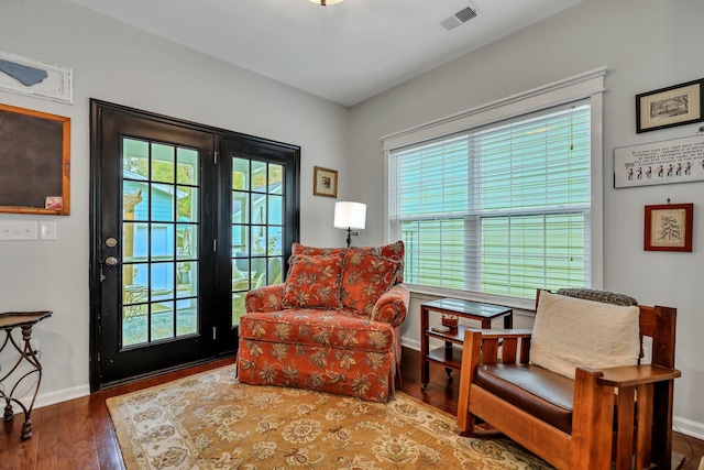 living area featuring hardwood / wood-style floors and a healthy amount of sunlight