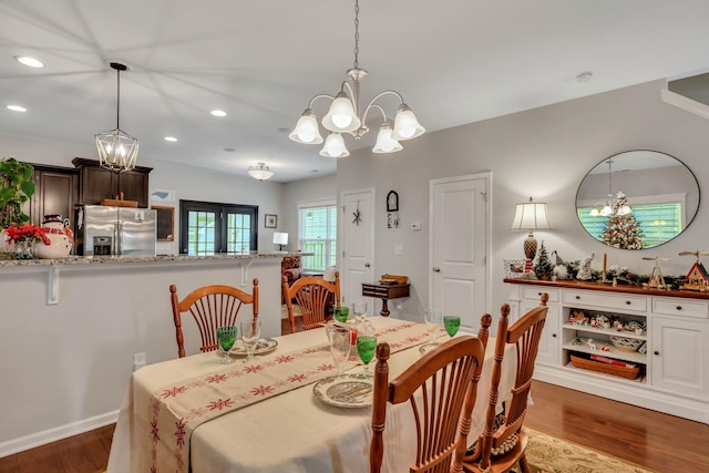 dining room featuring dark hardwood / wood-style floors, french doors, and a chandelier