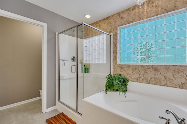 bathroom featuring tile patterned flooring and independent shower and bath