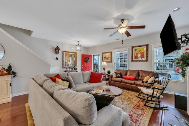 living room featuring dark hardwood / wood-style flooring and ceiling fan