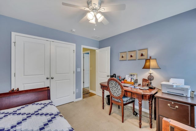 carpeted bedroom with ceiling fan and a closet