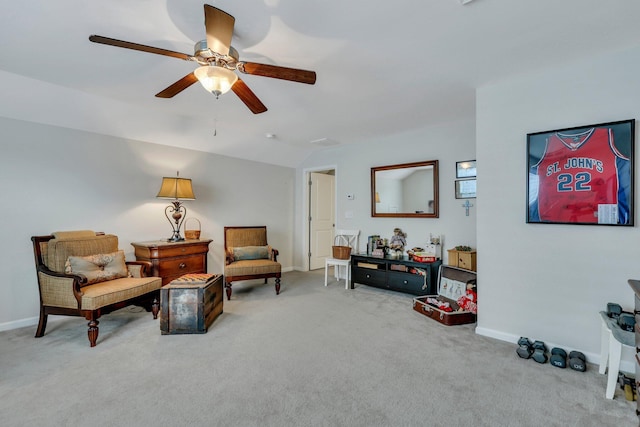 living area featuring carpet flooring and ceiling fan