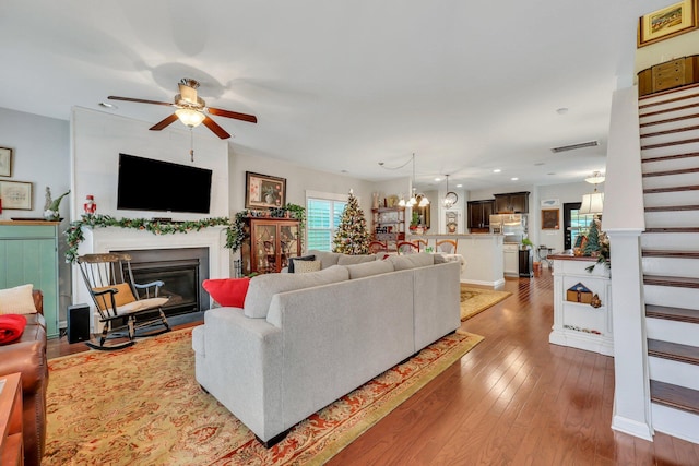 living room with ceiling fan and wood-type flooring