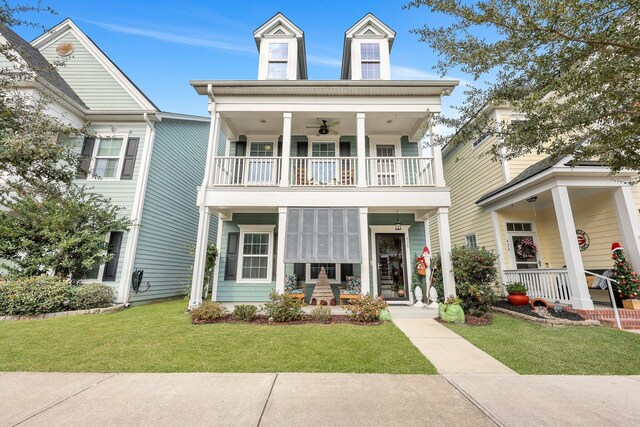 view of front of house with a balcony and a front yard