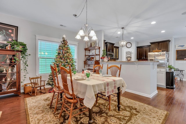 dining space featuring a chandelier and dark hardwood / wood-style floors