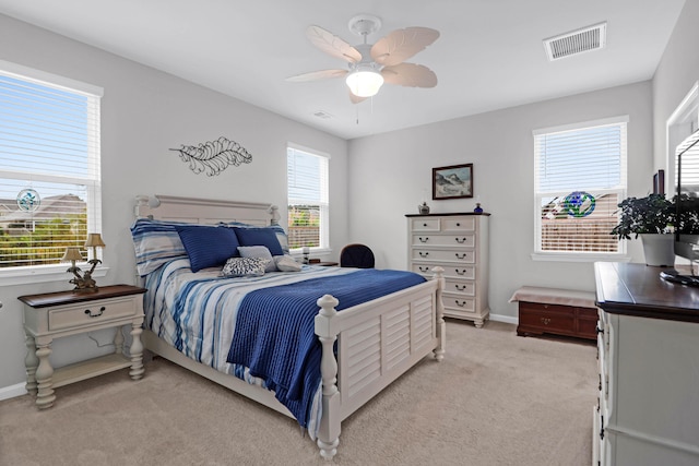 bedroom featuring light carpet and ceiling fan