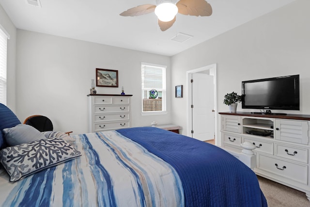 bedroom with light carpet and ceiling fan