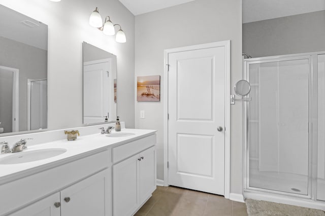 bathroom with vanity, a shower with shower door, and tile patterned flooring