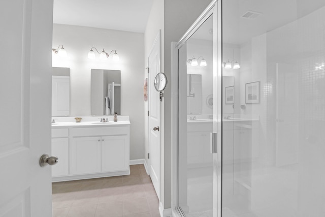 bathroom with vanity, an enclosed shower, and tile patterned floors