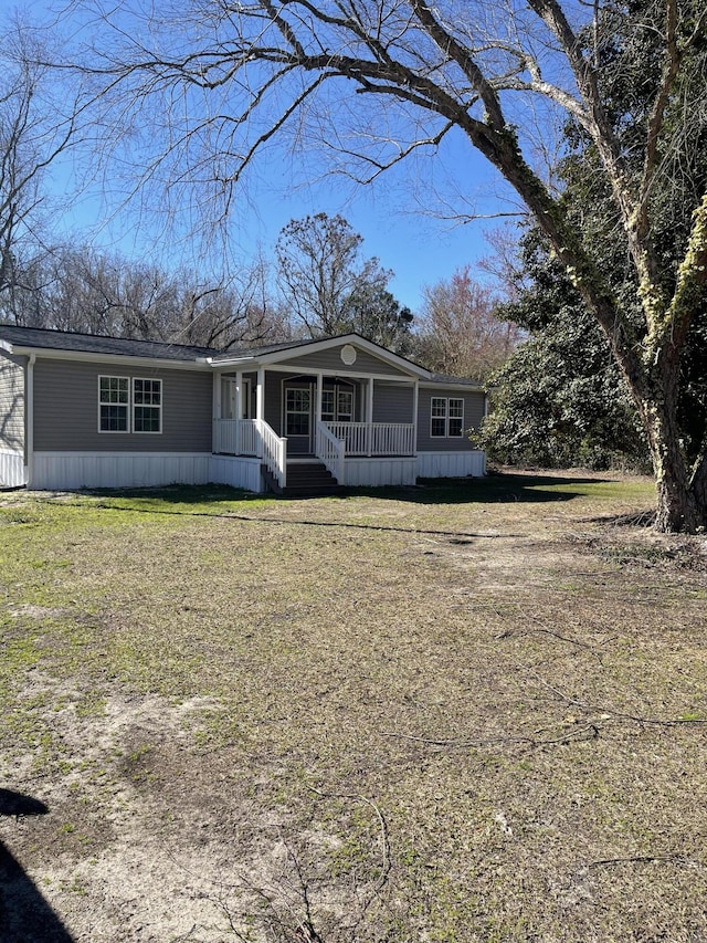 view of front of house featuring covered porch and a front yard