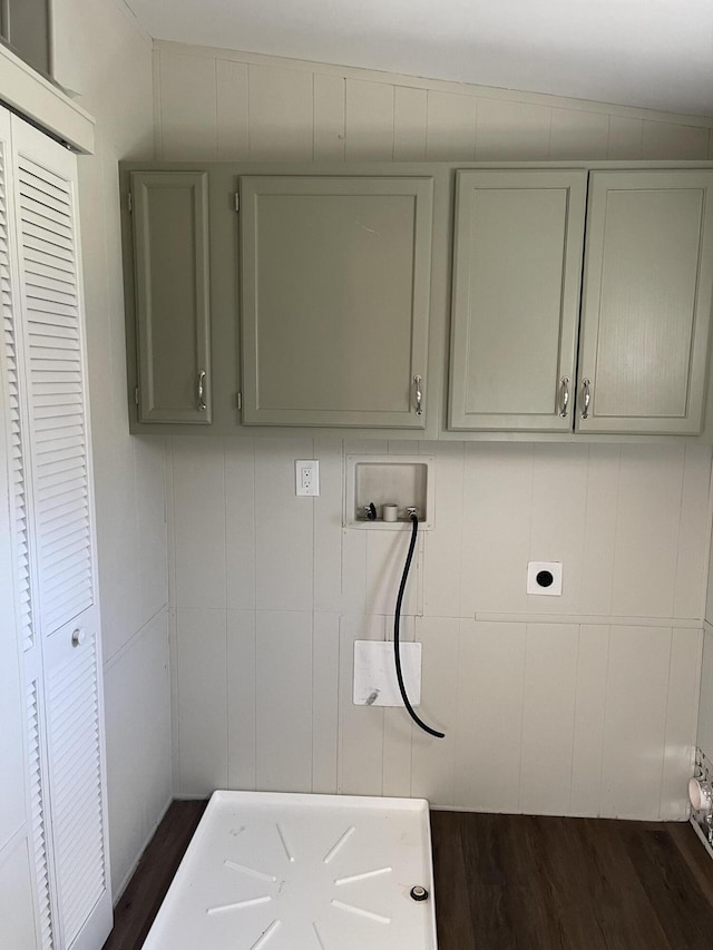 laundry room with dark wood finished floors, hookup for a washing machine, cabinet space, and hookup for an electric dryer