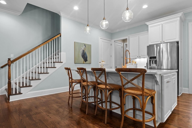 2792 River Vista Way, Mount Pleasant, SC 29466 - kitchen with stainless steel refrigerator with ice dispenser, dark wood-style flooring, an island with sink, white cabinets, and a kitchen bar