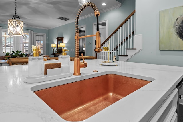 2792 River Vista Way, Mount Pleasant, SC 29466 - detailed view of a sink, crown molding, a chandelier, light stone counters, and hanging light fixtures