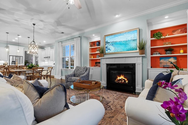 2792 River Vista Way, Mount Pleasant, SC 29466 - living room with ornamental molding, wood finished floors, a fireplace with flush hearth, built in shelves, and a ceiling fan