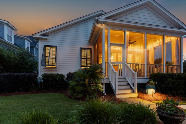 2792 River Vista Way, Mount Pleasant, SC 29466 - back of house at dusk featuring a sunroom and a lawn