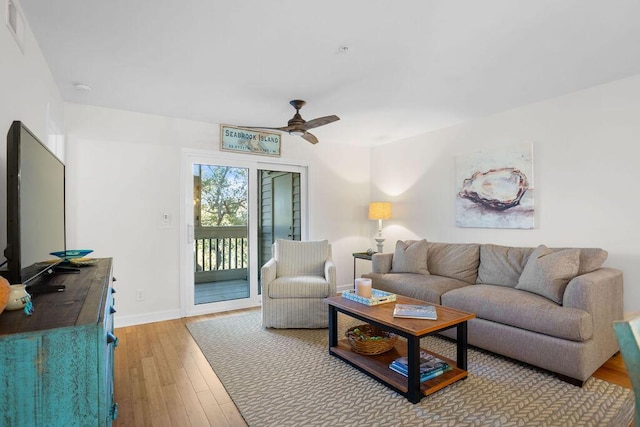 living room featuring light hardwood / wood-style floors and ceiling fan