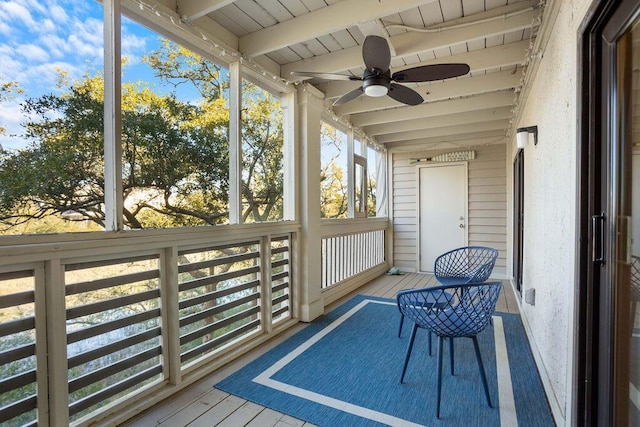 sunroom with beamed ceiling, ceiling fan, and wooden ceiling