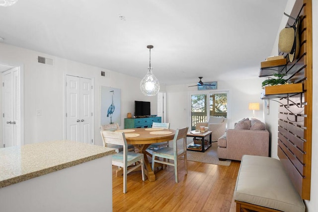 dining area with ceiling fan and light hardwood / wood-style floors