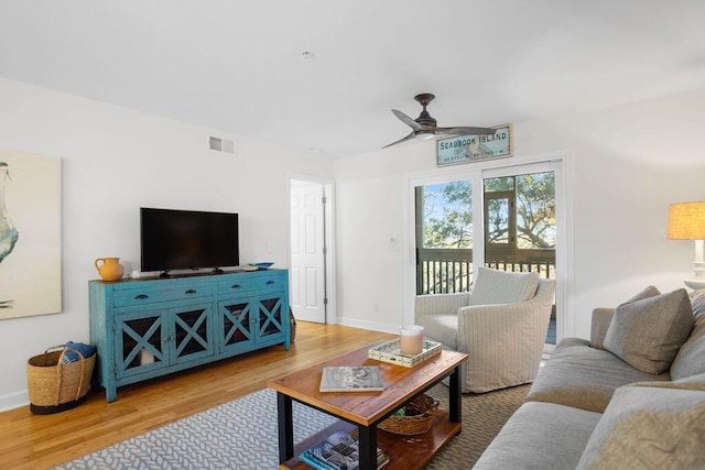 living room with hardwood / wood-style flooring and ceiling fan