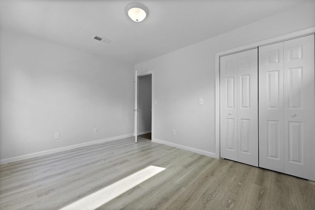 123 Lewisfield Dr, North Charleston, SC 29418 - unfurnished bedroom with light wood-style floors, baseboards, and a closet
