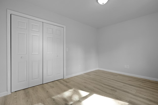123 Lewisfield Dr, North Charleston, SC 29418 - unfurnished bedroom with light wood-style floors, baseboards, and a closet