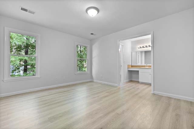 123 Lewisfield Dr, North Charleston, SC 29418 - unfurnished bedroom with light wood-style floors, multiple windows, and baseboards