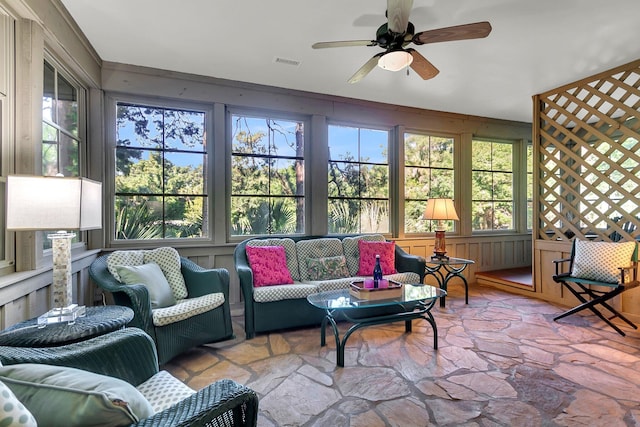 sunroom featuring ceiling fan