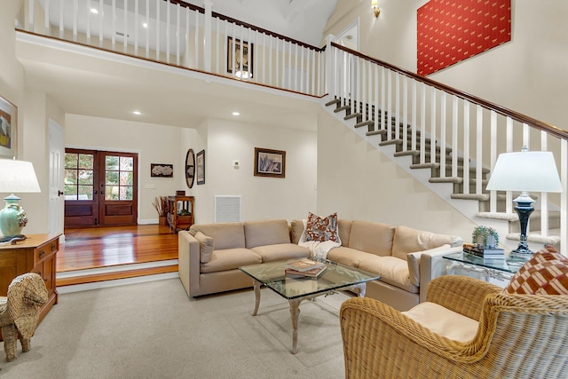 living room featuring a high ceiling and french doors