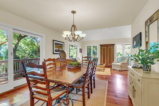 dining area with a notable chandelier and light wood-type flooring