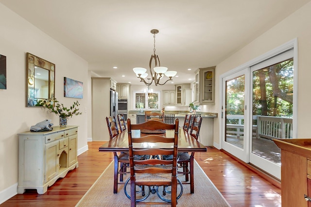 dining room featuring light hardwood / wood-style flooring and a chandelier