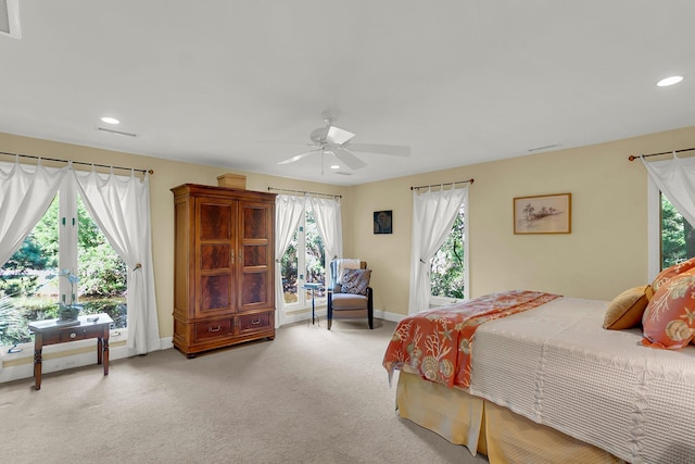 bedroom with ceiling fan and light colored carpet