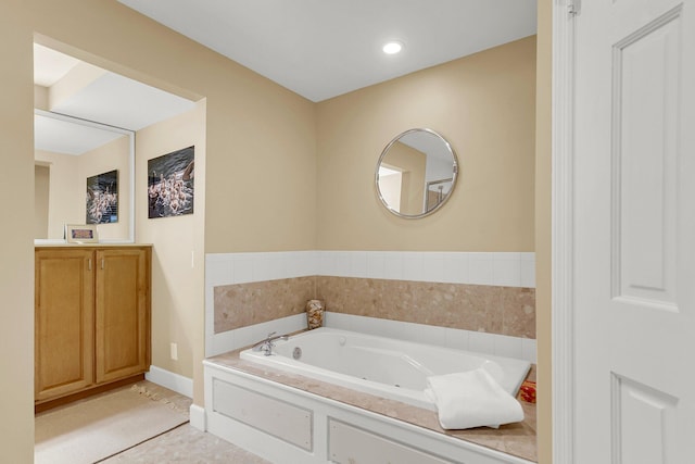 bathroom with tile patterned flooring and a bath